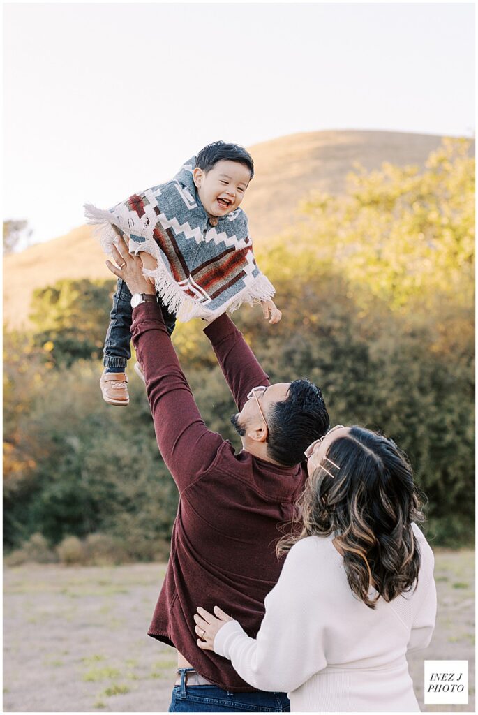 toddler being thrown in the air during family session